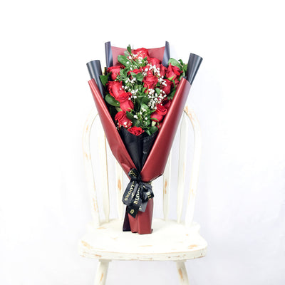This bouquet includes a selection of deep red roses, baby’s breath, and ruscus gathered in floral wrap with designer ribbon. Los Angeles Delivery