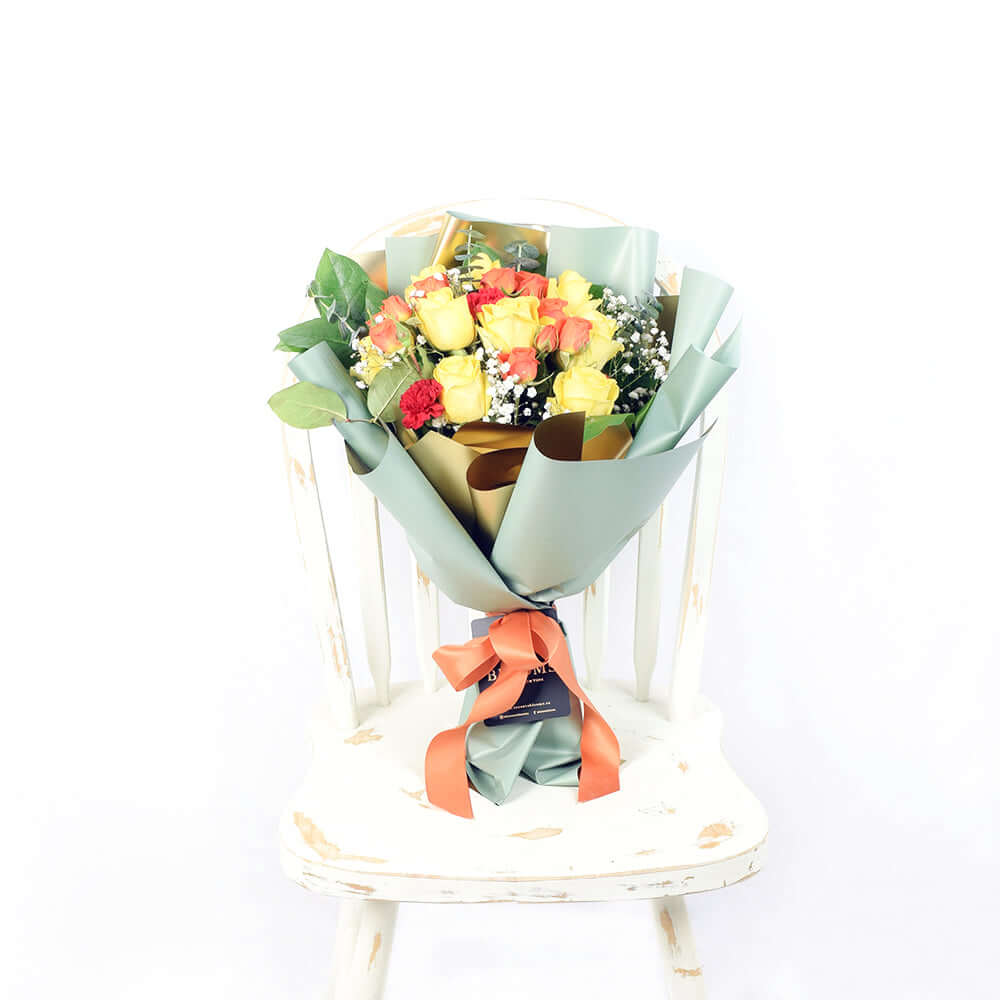 Vibrant Red, Yellow and Orange Rose Bouquet Wrapped with Ribbon – how the gift is presented